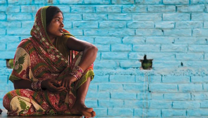 Sunita Kumari sits outside a community toilet facility