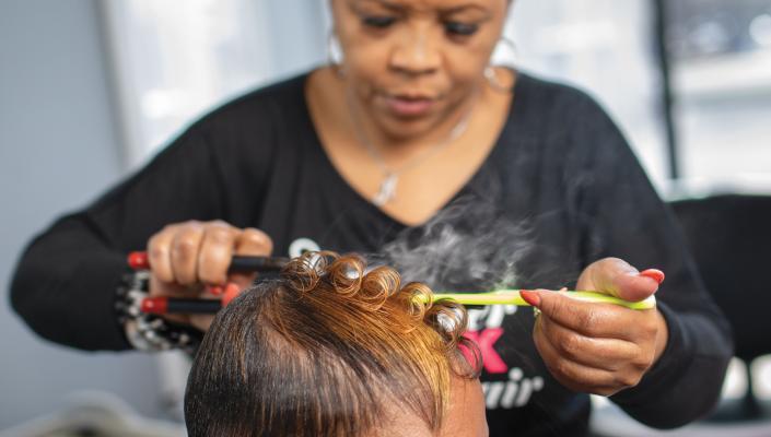 Katrina Randolph works on a client's hair in her salon.