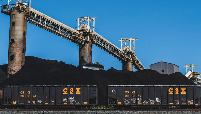 Baltimore's Curtis Bay Coal Piers, shown with two railroad cars full of coal in front of them.