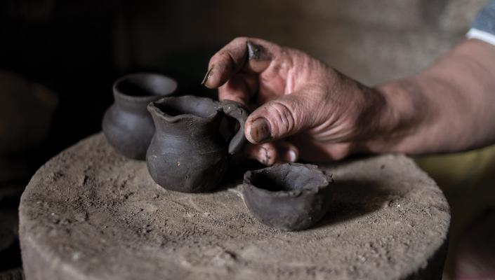 An artisan displays some of his pots.