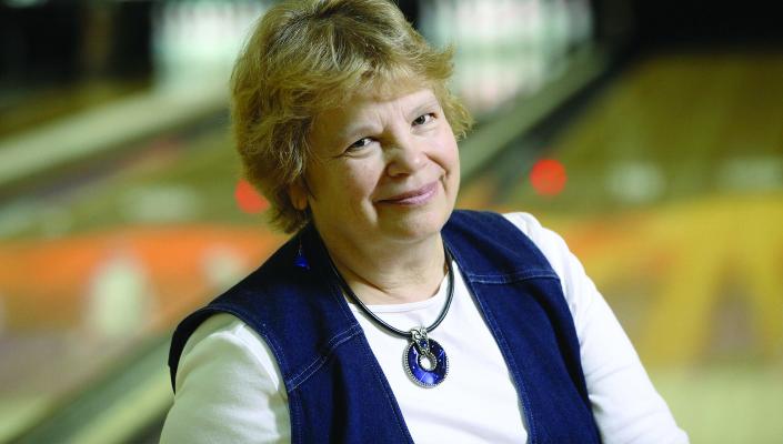 Peg Ensminger with a bowling alley in the background