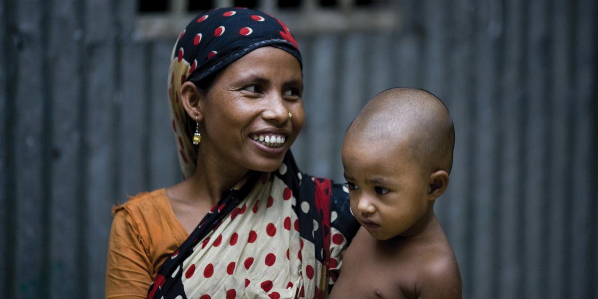 A woman in a scarf hold her child