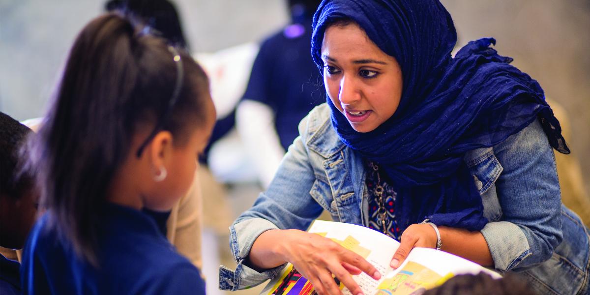 MPH student Mahendra Naidoo talks to an elementary student