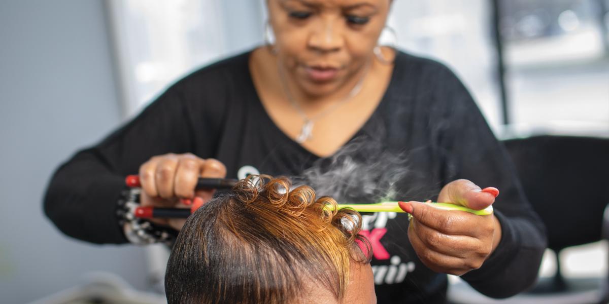 Katrina Randolph works on a client's hair in her salon.