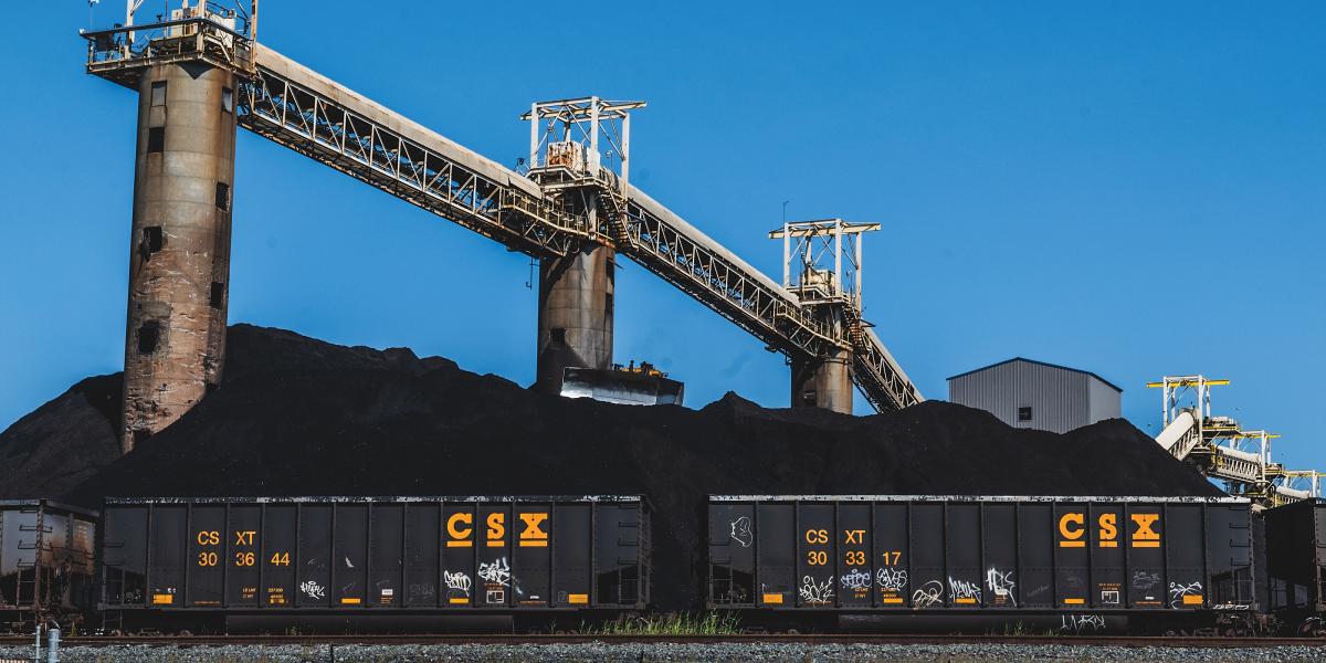 Baltimore's Curtis Bay Coal Piers, shown with two railroad cars full of coal in front of them.