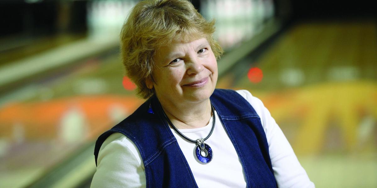 Peg Ensminger with a bowling alley in the background