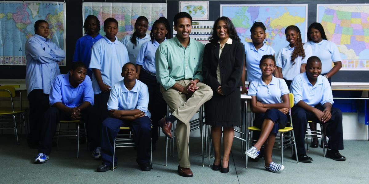 Bevin Philip and Rebekah Ghosh in a classroom with students wearing school uniforms