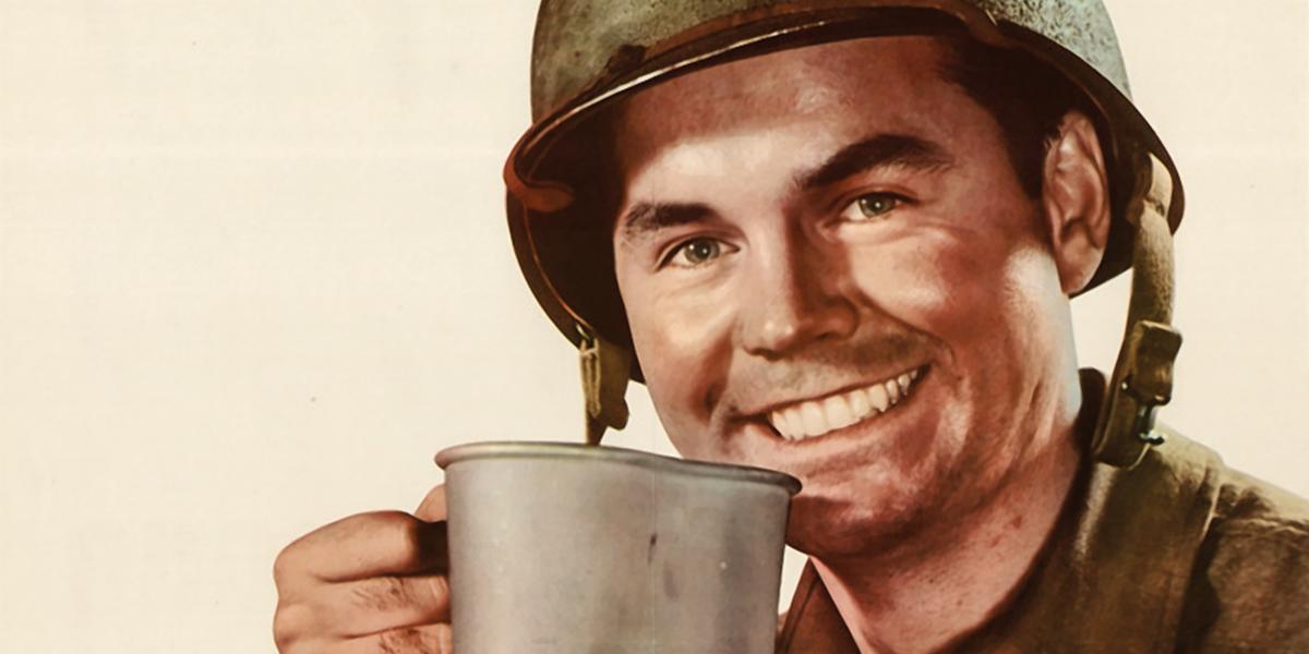 Smiling WWII GI drinking coffee