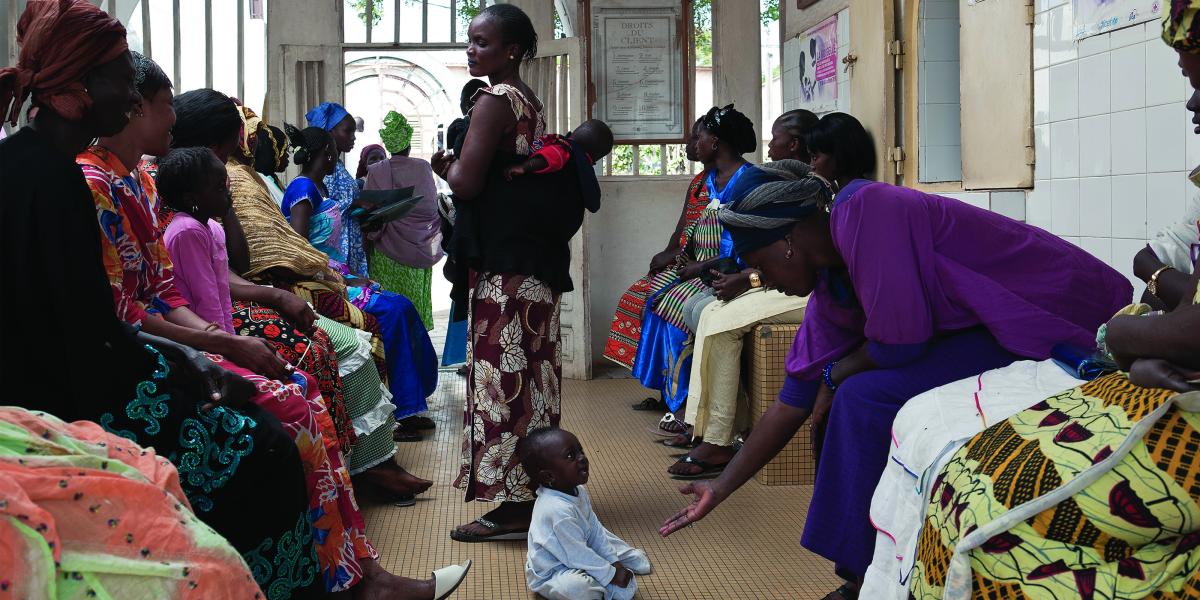 Women, seated and standing, in a clinic waiting room