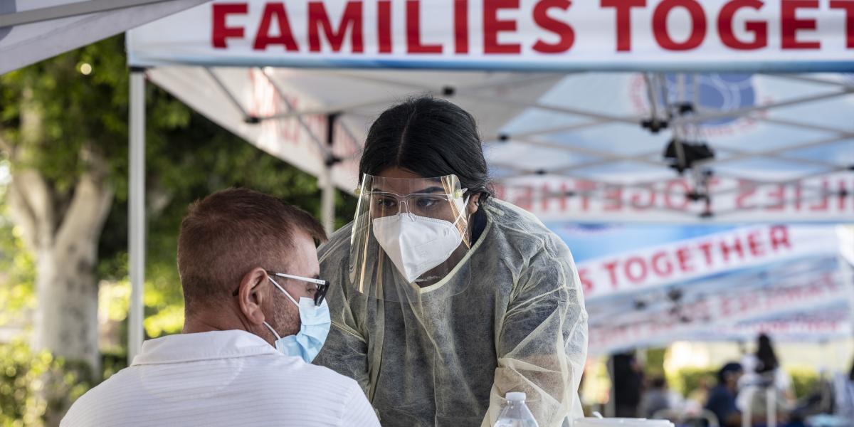 A medical assistant takes the blood pressure of a man at a monkeypox vaccination clinic at Families Together of Orange County in Tustin, CA on Tuesday, August 16, 2022. 