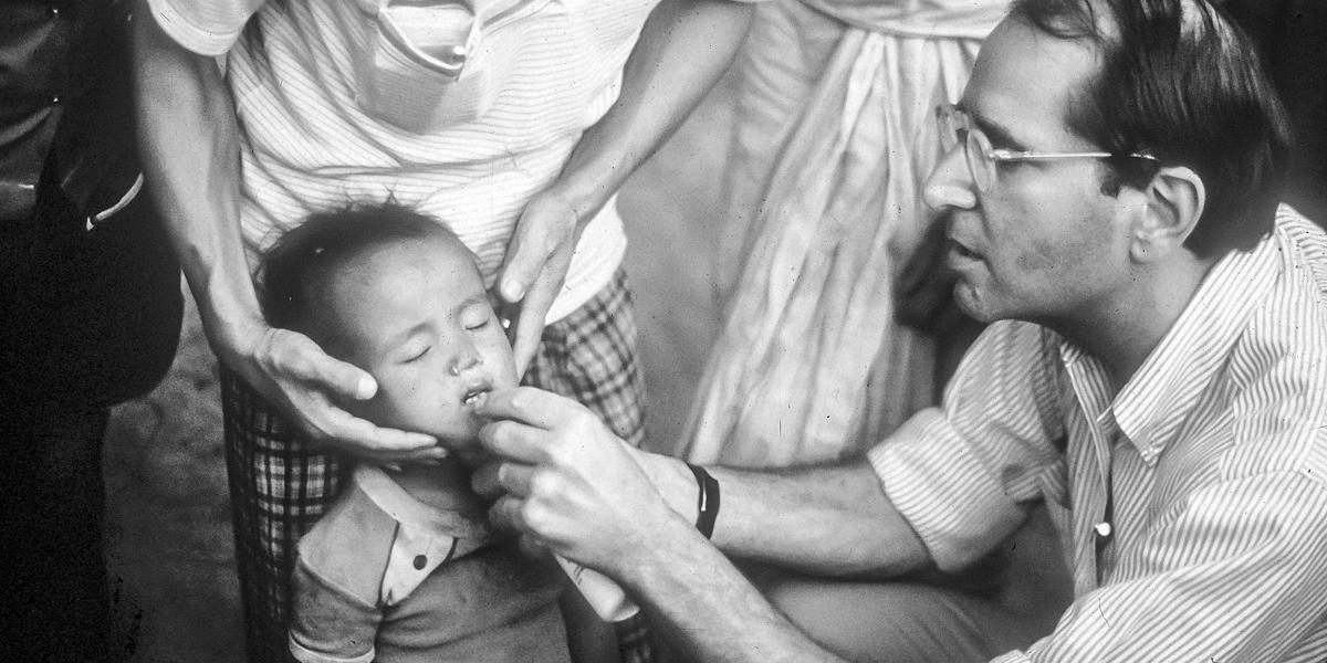 Al Sommer gives a small child vitamin A drops