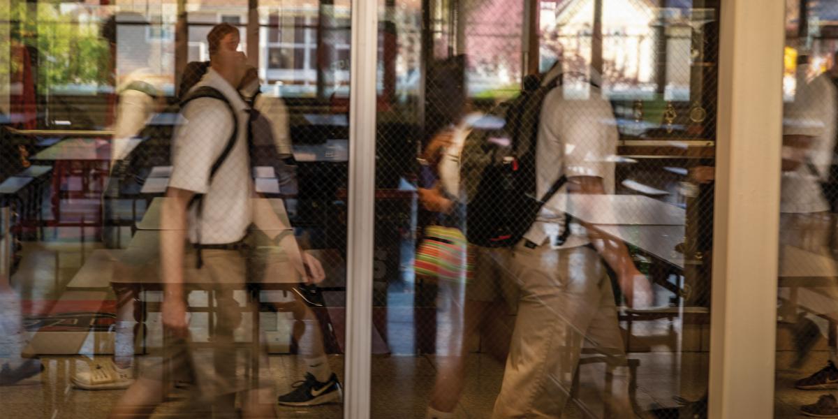 student walking past window