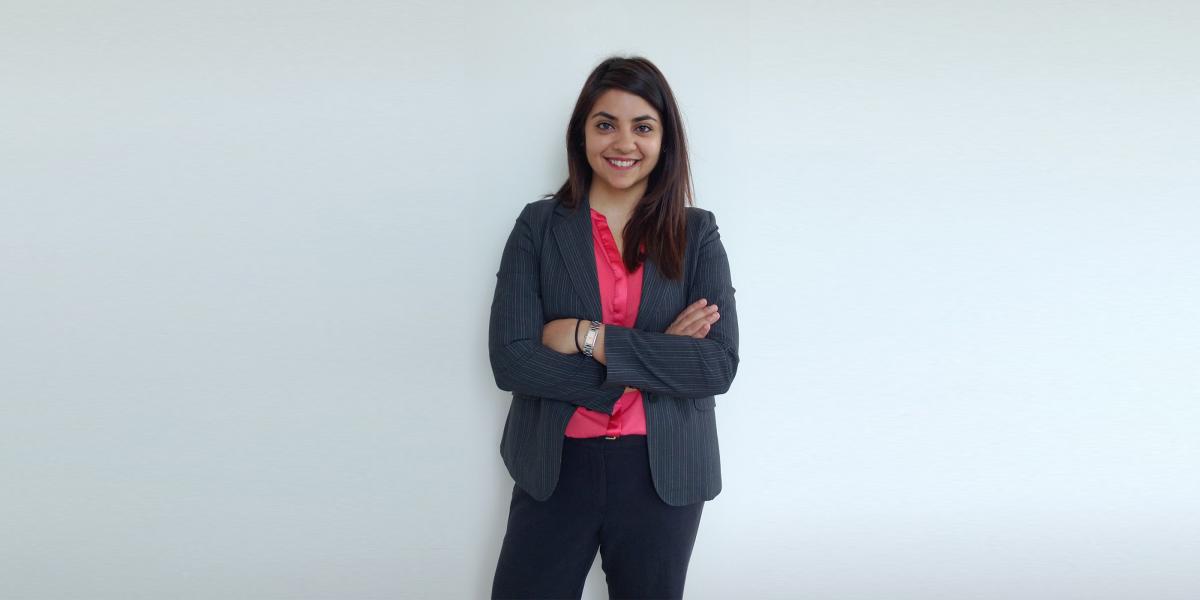 Guarvika Nayyar stands with her arms folded across her chest