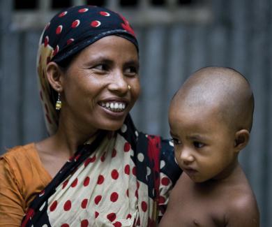 A woman in a scarf hold her child