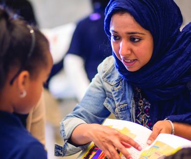 MPH student Mahendra Naidoo talks to an elementary student