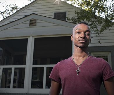 Tavon Vinson stands in front of his Baltimore home