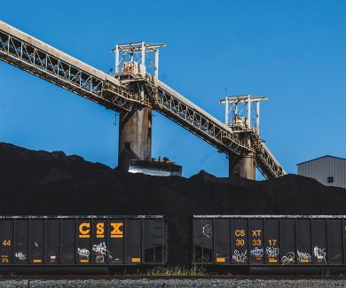 Baltimore's Curtis Bay Coal Piers, shown with two railroad cars full of coal in front of them.