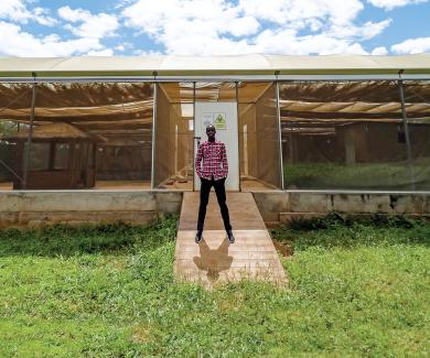 Entomologist Limonty Simubali stands in front of the “mosquito house” in Macha, Zambia, on March 30, 2022.