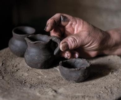 An artisan displays some of his pots.