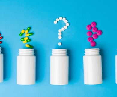  Prescription bottles and pills forming a question mark