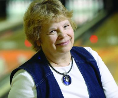 Peg Ensminger with a bowling alley in the background