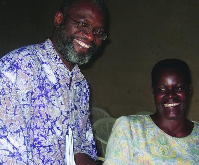 Nosa Orobaton and a Ugandan community medicine distributor