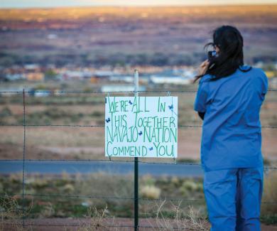 A nurse practitioner snaps a photo on April 8 in Apache County, Arizona—the middle of the Navajo Nation. Beside her, a handmade sign thanks local hospital staff during the pandemic. 