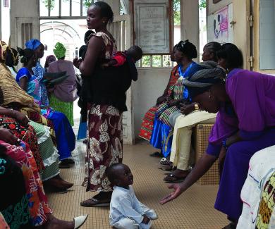 Women, seated and standing, in a clinic waiting room