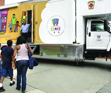 A family of 3 approaches the CARES van