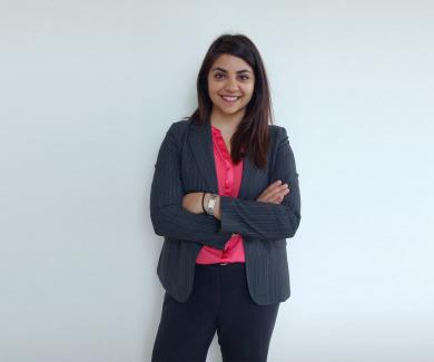 Guarvika Nayyar stands with her arms folded across her chest